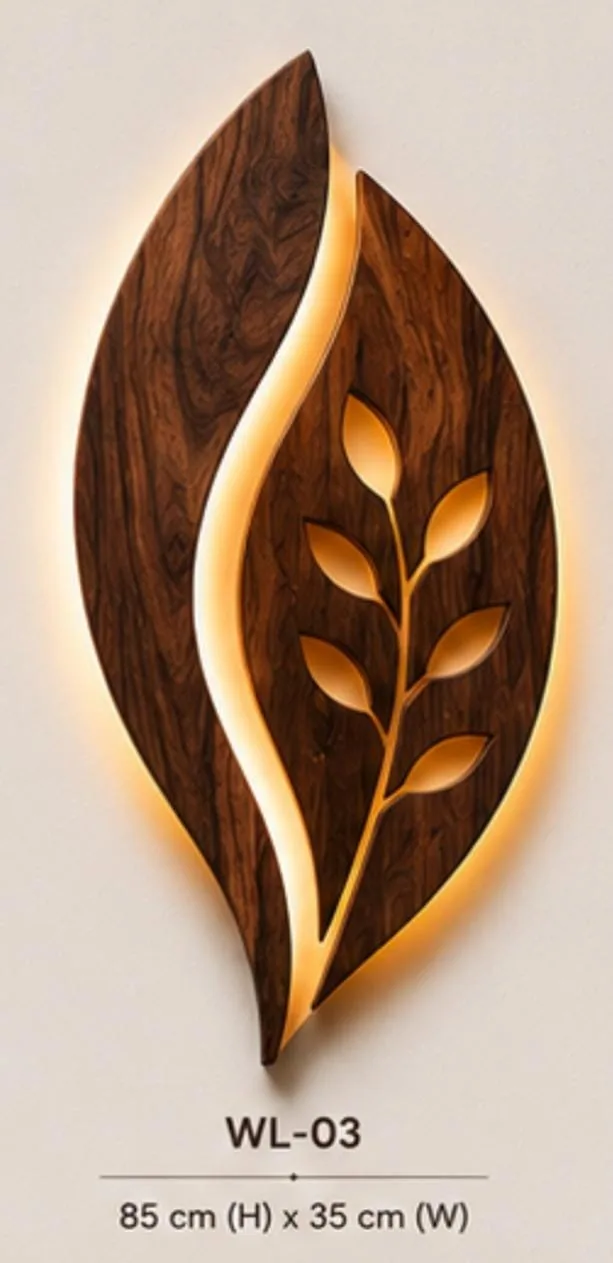 Carved wooden leaf wall lamp with a branch of cut-out leaves glowing with warm LED light