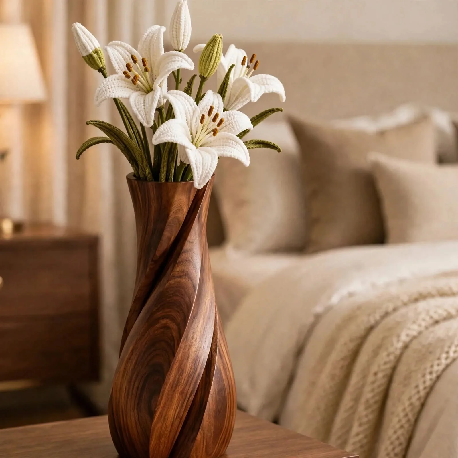 Handcrafted tall twisted floor vase with white lilies on bedroom nightstand beside candle and cozy bedding