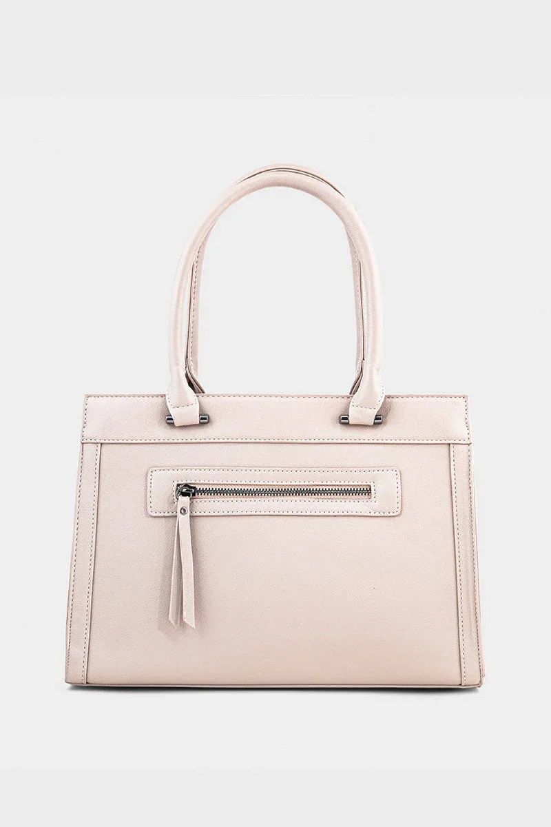 Front view of blush beige faux leather structured top handle tote bag with front zip pocket and tassel pull and silver hardware on white background