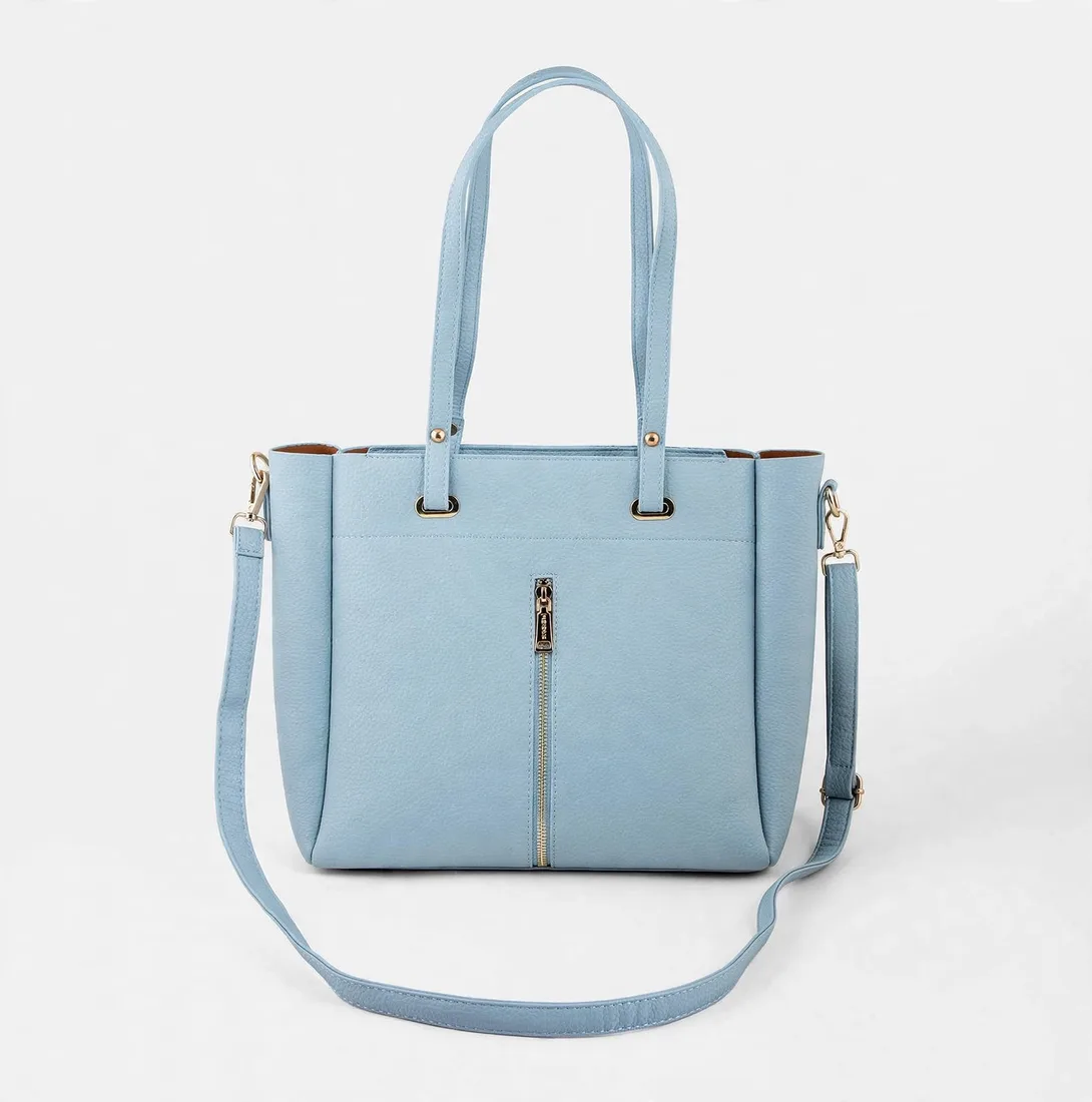 Front view of sky blue pebbled faux leather tote bag with gold vertical zipper